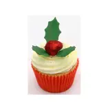 Un cupcake festif orné d'une baie rouge pailletée et d'une feuille de houx verte.