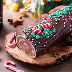 Bûche de Noël chocolatée, décorée de sucre d'orge et de vermicelles verts. Parfaite pour une recette de bûche de Noël à congeler.