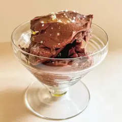 Glace au chocolat onctueuse, parsemée de sel, dans un verre à pied. Un délice de ganache coco.