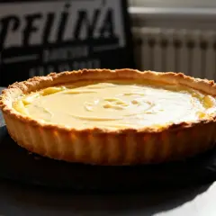 Flan pâtissier on a pâte feuilletée or brisée, with a creamy custard filling, ready to be enjoyed.