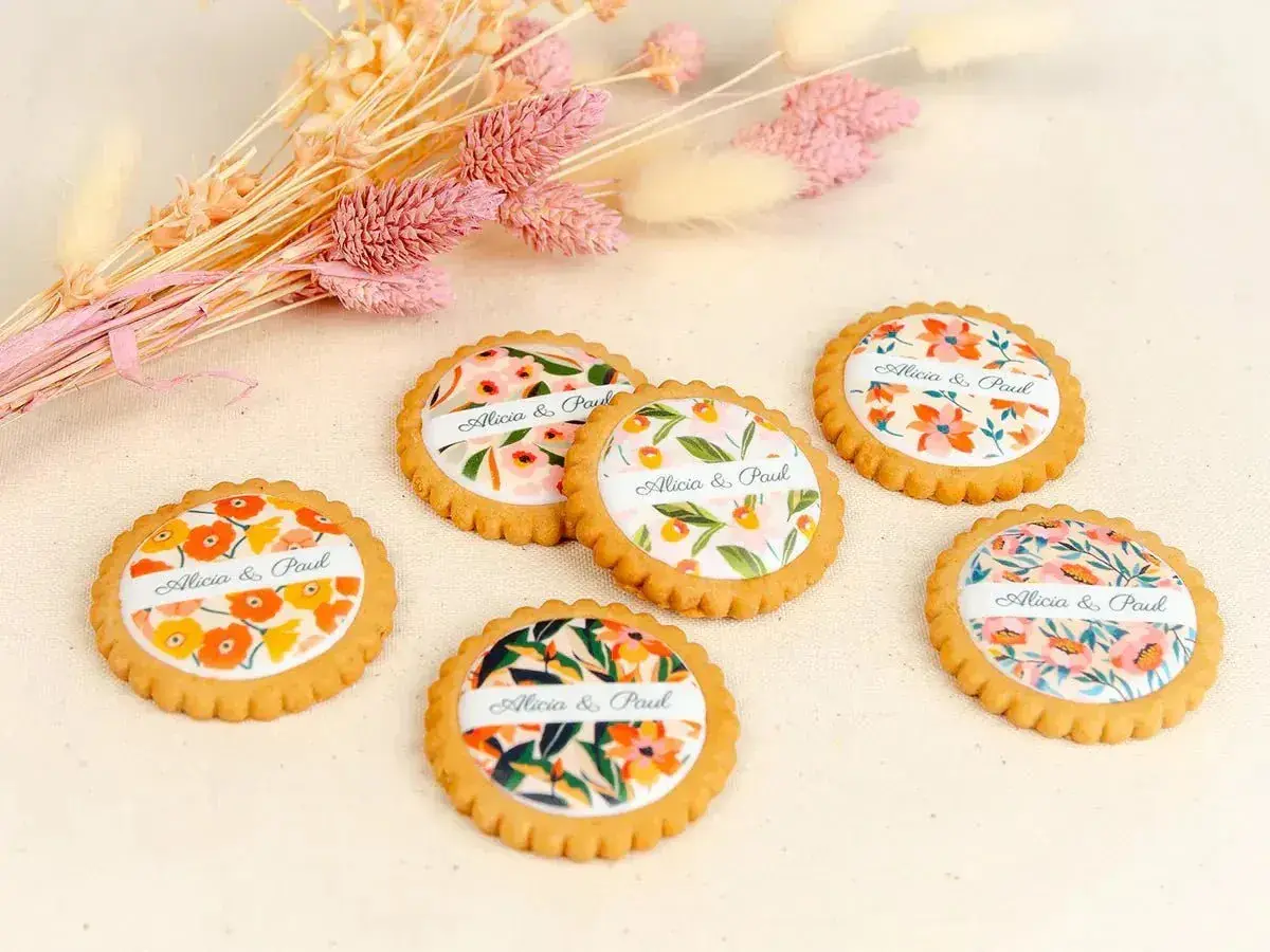 Six biscuits personnalisés avec des motifs floraux et les noms "Alicia & Paul", parfaits pour une recette biscuit personnalisé.