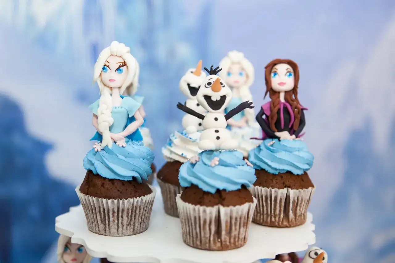 Petits g&acirc;teaux d&eacute;cor&eacute;s avec des personnages de la Reine des Neiges en p&acirc;te &agrave; sucre. Id&eacute;al pour apprendre comment travailler la p&acirc;te &agrave; sucre et cr&eacute;er des d&eacute;corations magiques.