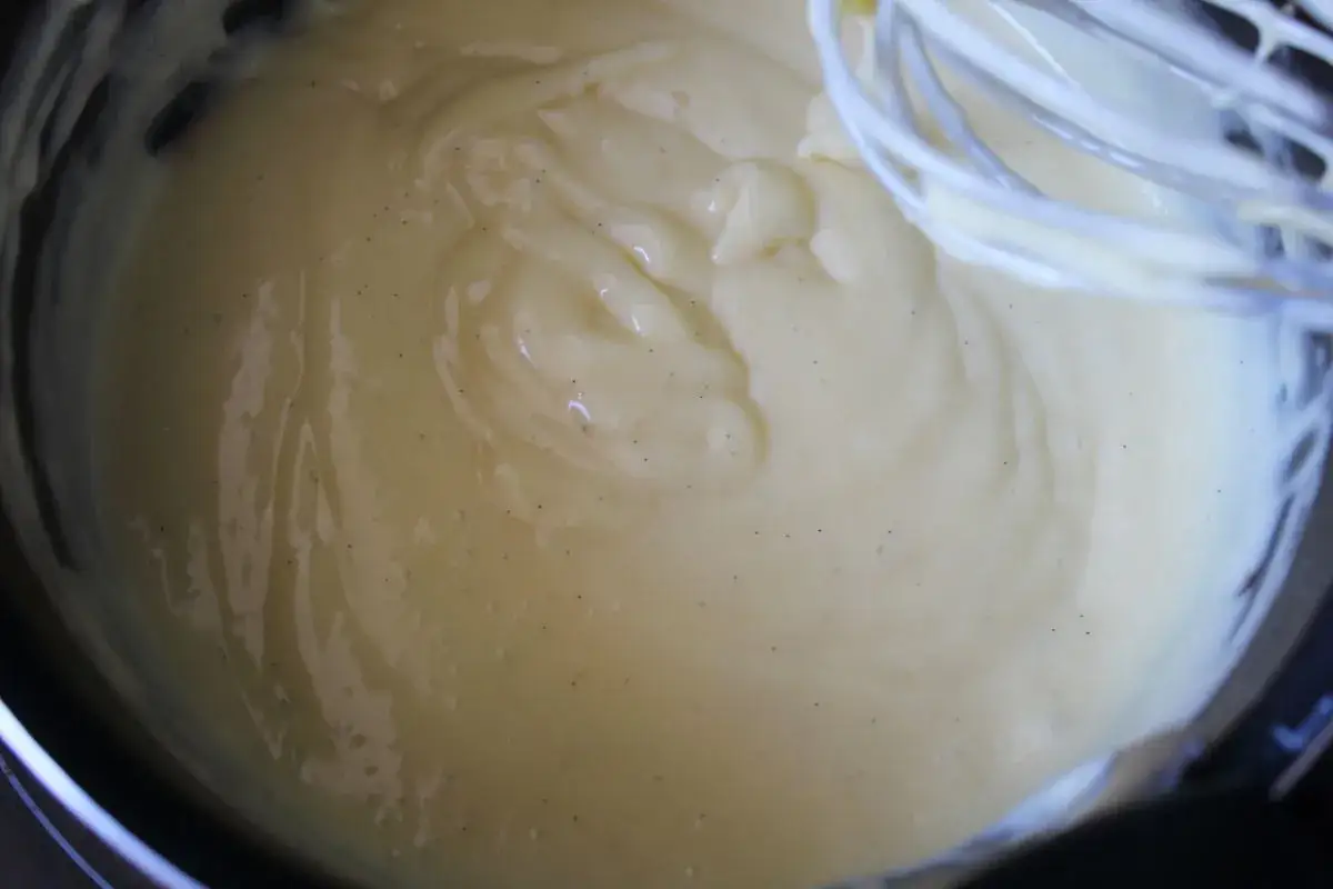Crème pâtissière sans oeuf, onctueuse et parsemée de points de vanille, prête à garnir vos desserts.